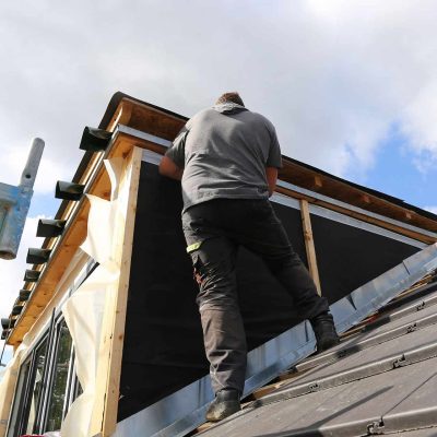 Roofing contractor working on a new dormer
